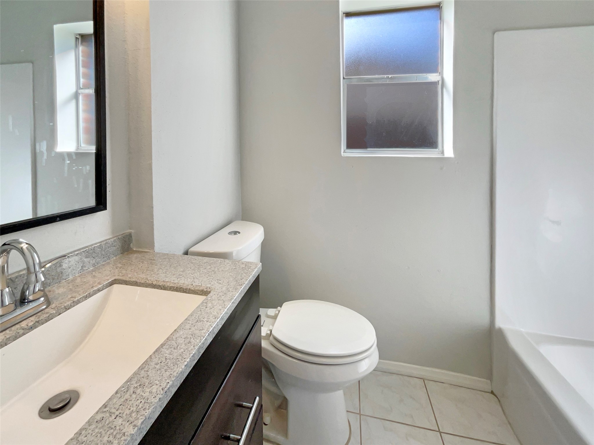 205 Bastrop Street Angleton, TX 77515 - Photo 6 of 18 a bathroom with a granite countertop sink and a mirror