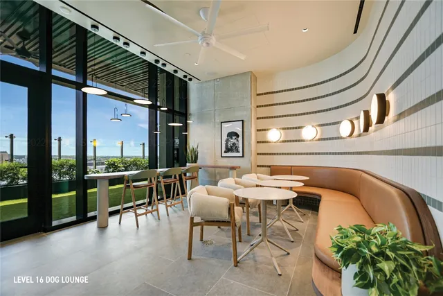 a living room with furniture a ceiling fan and a rug