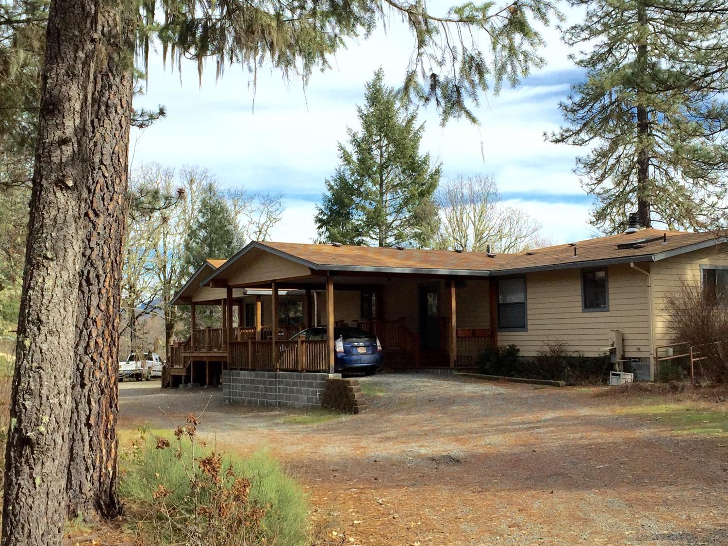 5707 Rockydale Road Cave Junction, OR 97523 - Photo 33 of 35 a view of a house with a yard