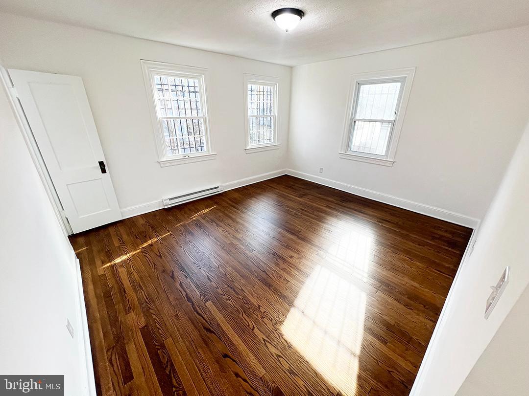 2011 16th Street Southeast Washington, DC 20020 - Photo 13 of 19 an empty room with wooden floor and windows