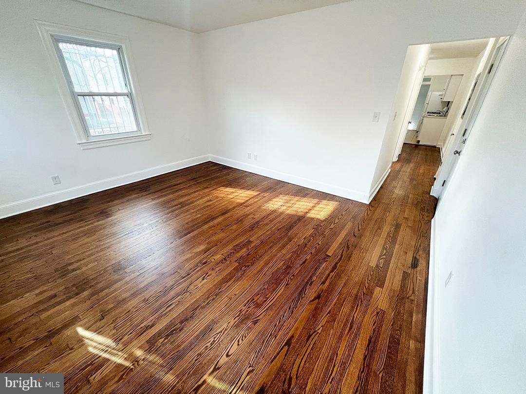2011 16th Street Southeast Washington, DC 20020 - Photo 14 of 19 an empty room with wooden floor and windows
