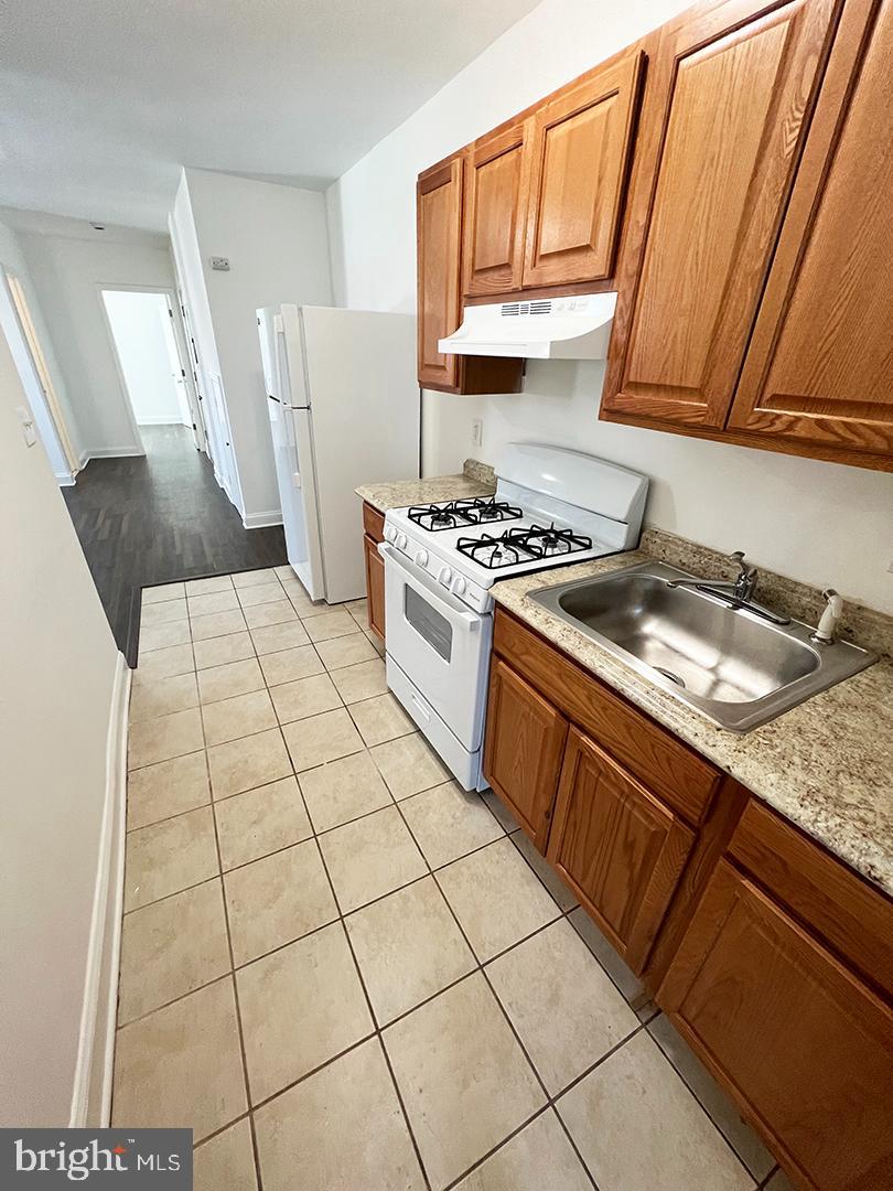 2011 16th Street Southeast Washington, DC 20020 - Photo 16 of 19 a kitchen with a sink a stove top oven and cabinetry