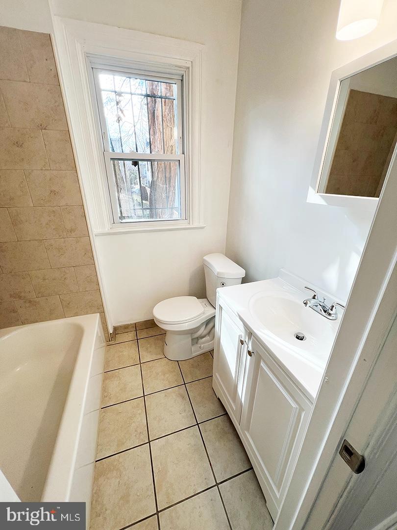 2011 16th Street Southeast Washington, DC 20020 - Photo 18 of 19 a bathroom with a sink a toilet a mirror and a window