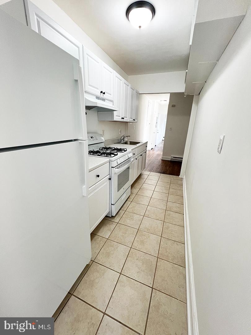 2011 16th Street Southeast Washington, DC 20020 - Photo 4 of 19 a kitchen with a stove a refrigerator and a sink
