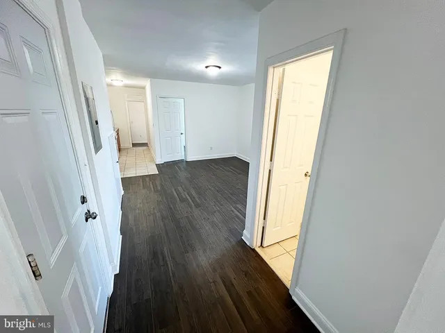 a view of hallway with wooden floor and stairs
