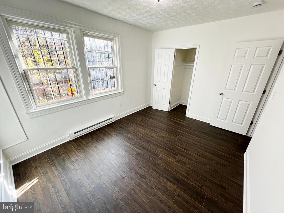 2011 16th Street Southeast Washington, DC 20020 - Photo 8 of 19 a view of an empty room with wooden floor and a window