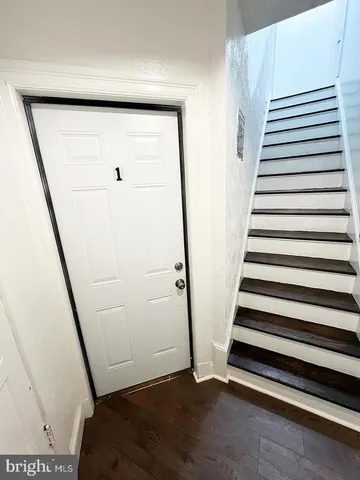 a view of entryway with stairs and wooden floor