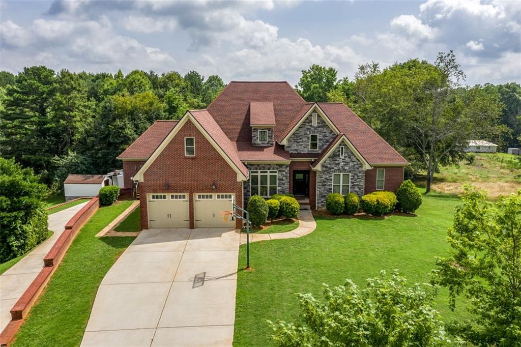 598 Tanner Road Dacula, GA 30019 - Photo 1 of 1 a front view of house with yard and green space