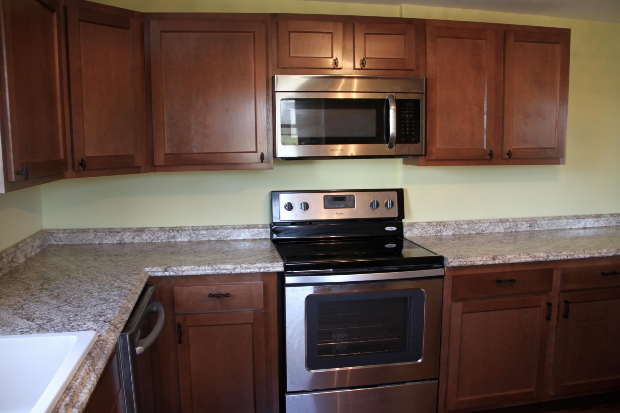 1295 Zion Ridge Road Loudon, TN 37774 - Photo 8 of 40 a kitchen with granite countertop wood cabinets and stainless steel appliances
