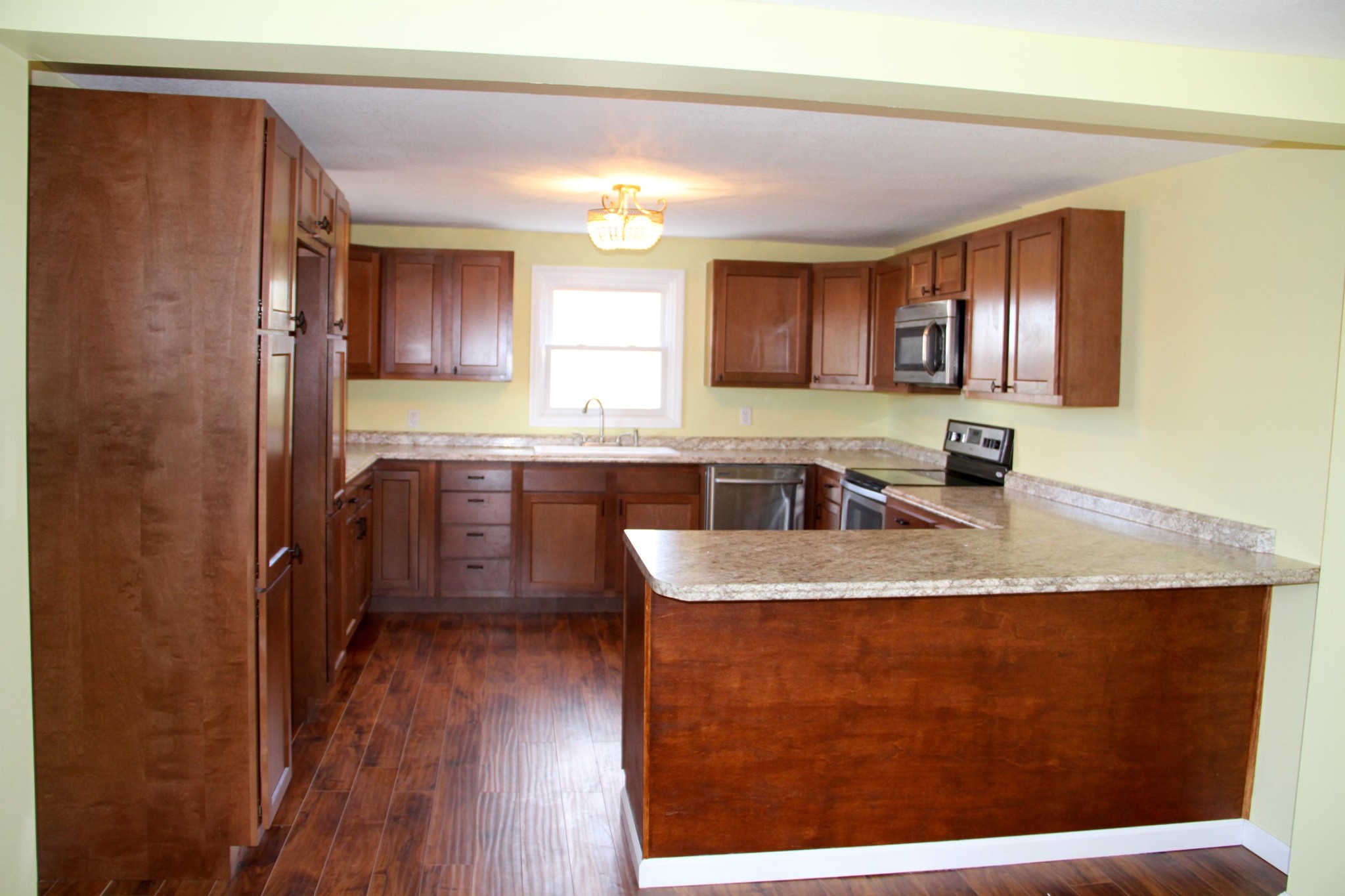 1295 Zion Ridge Road Loudon, TN 37774 - Photo 10 of 40 a kitchen with kitchen island granite countertop a sink window and cabinets