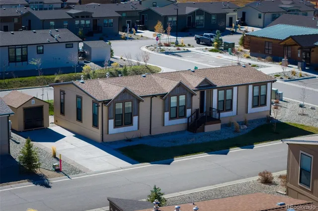 a aerial view of a house with swimming pool and sitting area