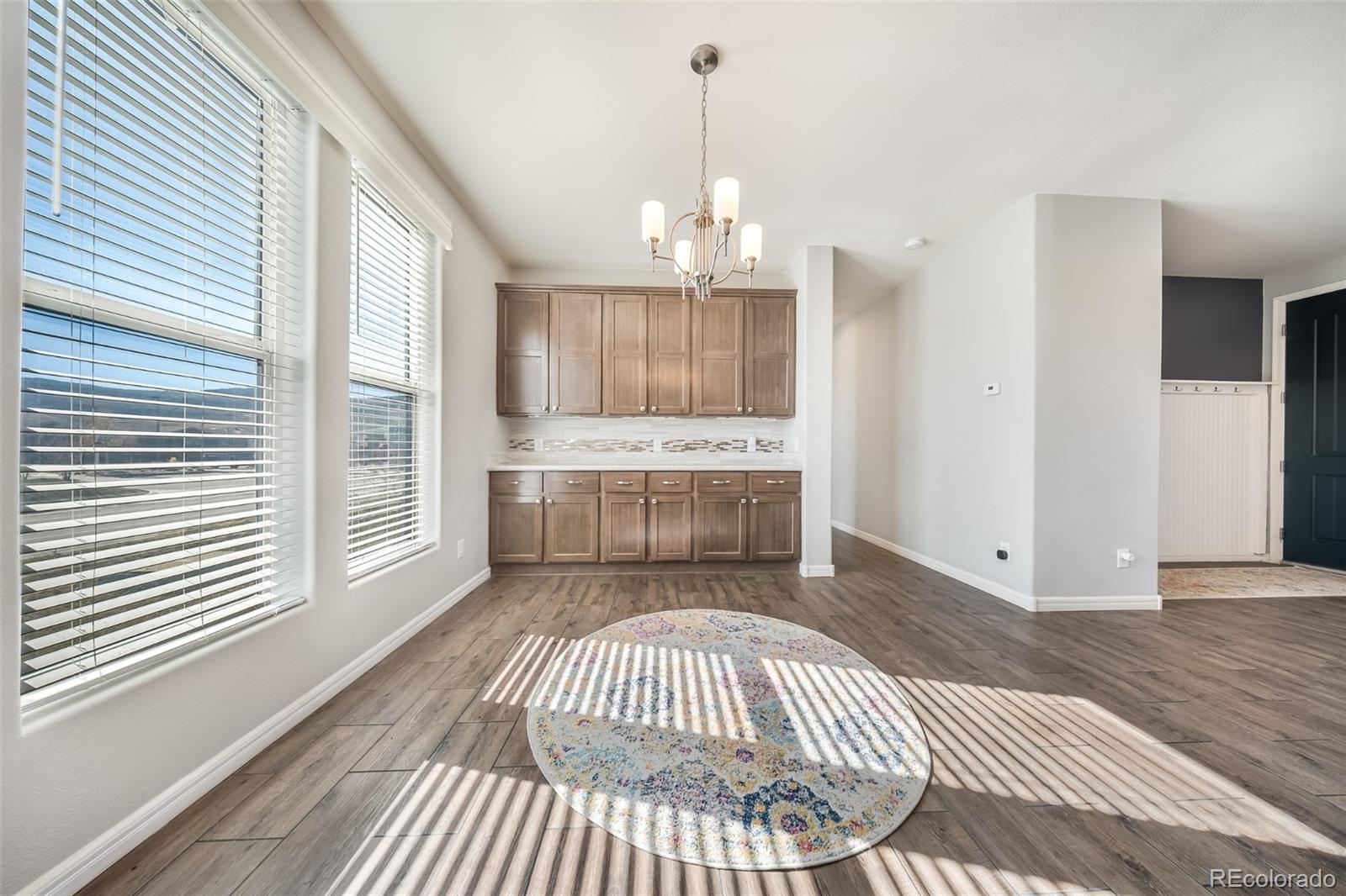 551 Summit Trail Granby, CO 80446 - Photo 11 of 35 a view of a livingroom with wooden floor and kitchen space