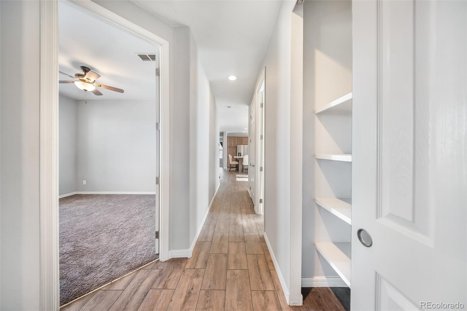 551 Summit Trail Granby, CO 80446 - Photo 12 of 35 a view of a hallway with wooden floor and staircase