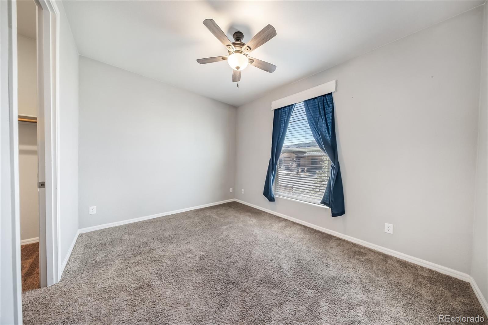 551 Summit Trail Granby, CO 80446 - Photo 21 of 35 an empty room with windows and ceiling fan