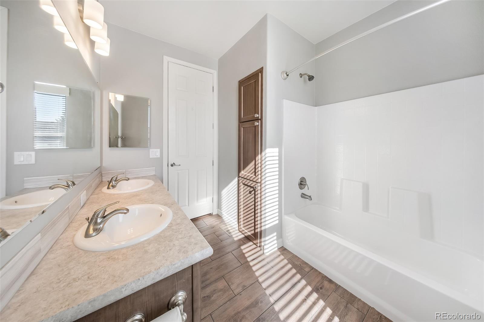 551 Summit Trail Granby, CO 80446 - Photo 23 of 35 a bathroom with a sink double vanity granite tub shower and a mirror