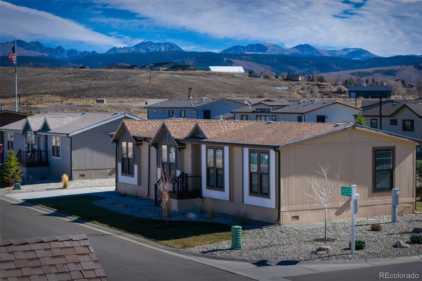 551 Summit Trail Granby, CO 80446 - Photo 31 of 35 a front view of a building with a garden and mountain view
