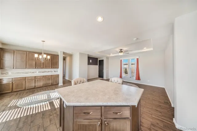 a large white kitchen with a large window