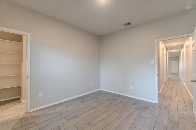 a view of an empty room and wooden floor