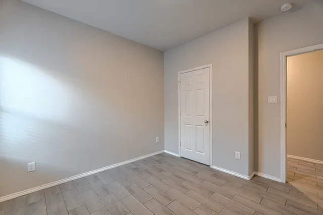 a view of an empty room and wooden floor