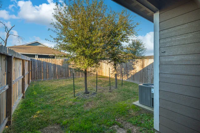 a view of a backyard with wooden fence