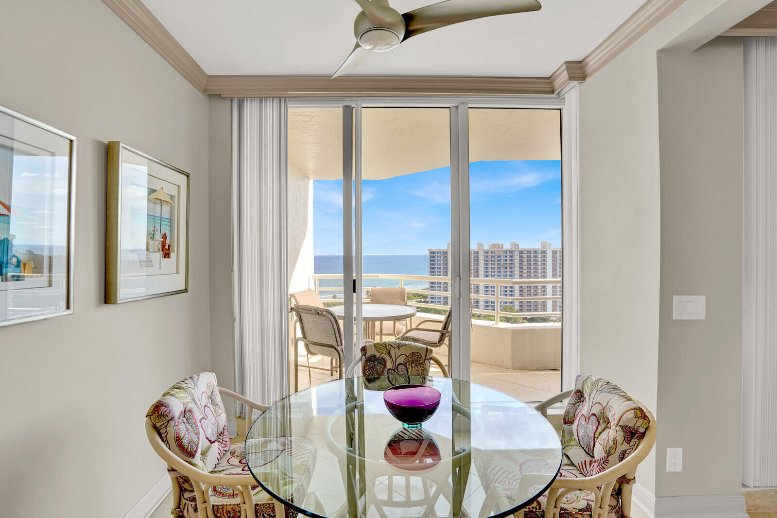 4201 North Ocean Boulevard, Unit PH1806 Boca Raton, FL 33431 - Photo 17 of 47 a view of a dining room with furniture large windows and wooden floor