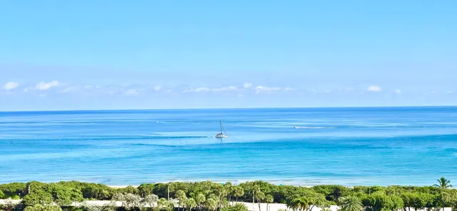 a large bathroom with a large mirror vanity and shower