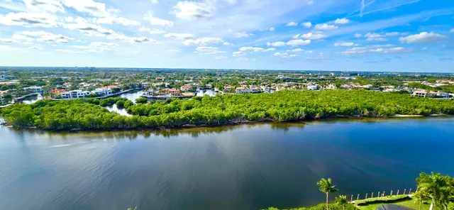 a living room with furniture a rug and white walls