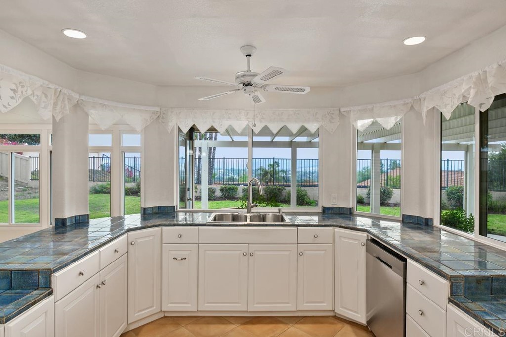 2248 Winsome Place Escondido, CA 92029 - Photo 11 of 26 a large white kitchen with a large window and sink