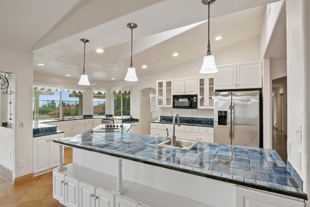 2248 Winsome Place Escondido, CA 92029 - Photo 9 of 26 a kitchen with counter top space cabinets and stainless steel appliances
