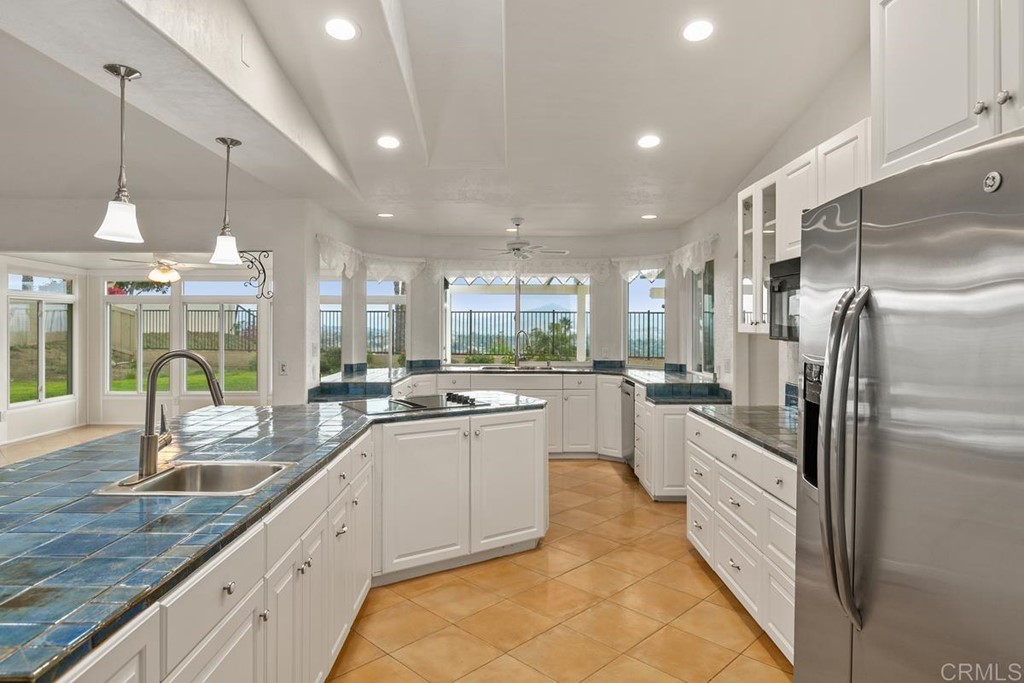 2248 Winsome Place Escondido, CA 92029 - Photo 10 of 26 a kitchen with counter top space cabinets and stainless steel appliances