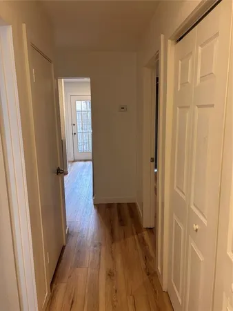 a view of a hallway with wooden floor