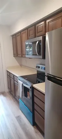 a kitchen with stainless steel appliances a refrigerator and a stove top oven