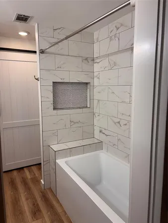 a bathroom with a tub and a shower