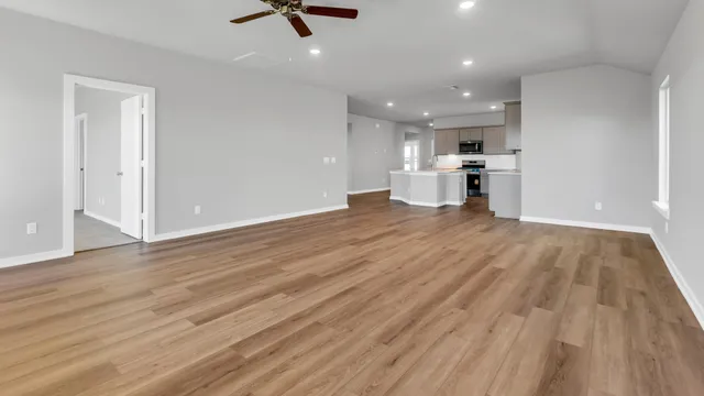 a view of a kitchen with a sink and wooden floor