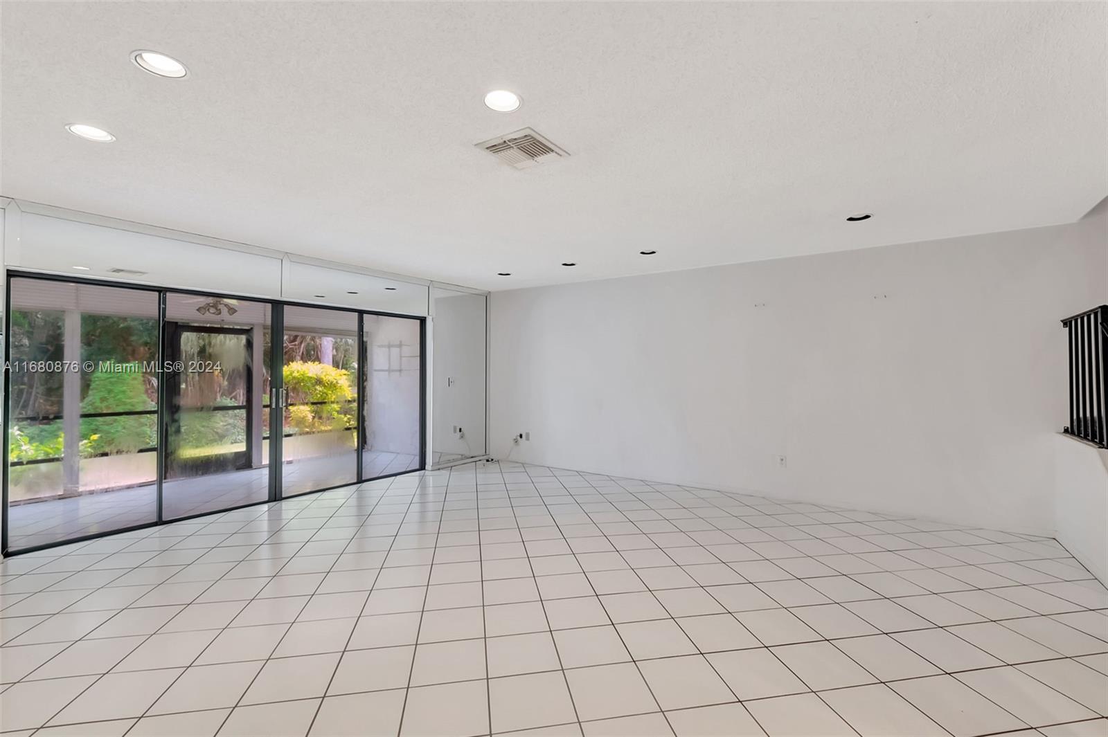 21864 Arriba Real, Unit 3E Boca Raton, FL 33433 - Photo 14 of 61 an empty room with floor to ceiling window and ceiling fan