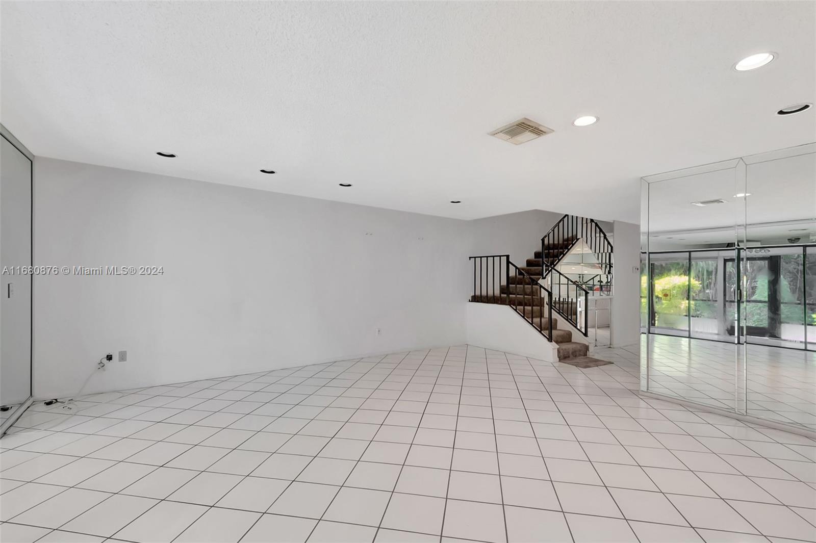 21864 Arriba Real, Unit 3E Boca Raton, FL 33433 - Photo 16 of 61 an empty room with white walls and stairs