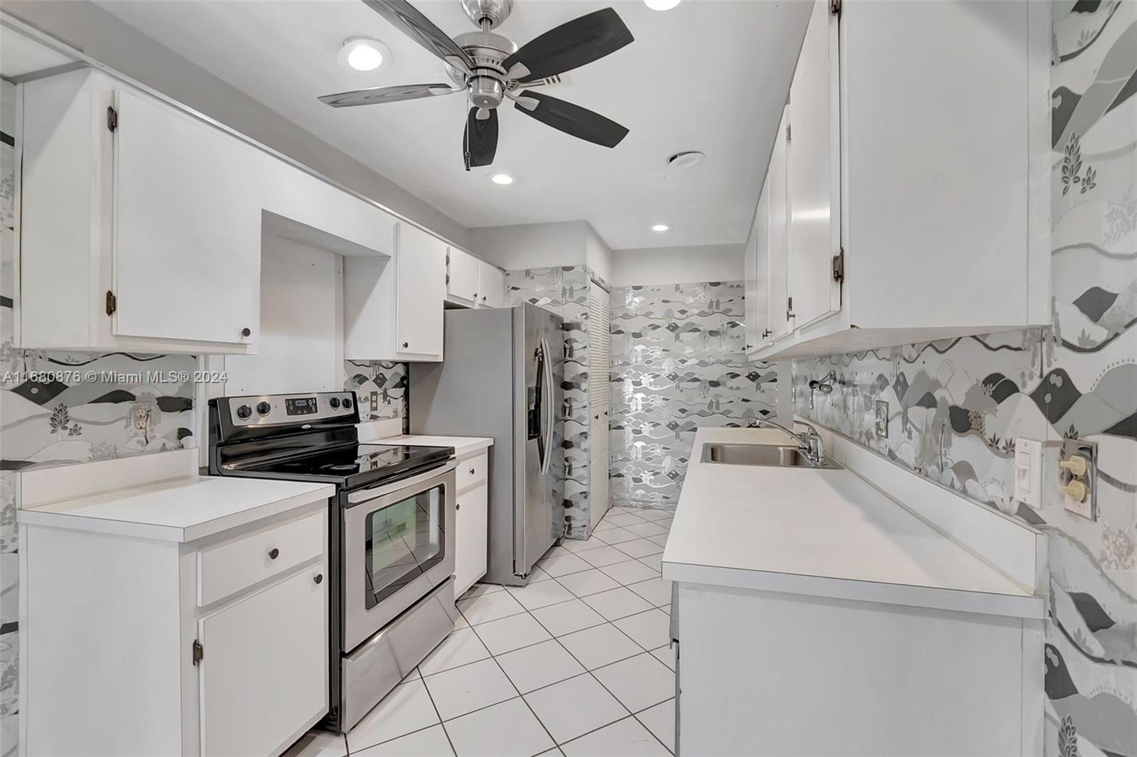 21864 Arriba Real, Unit 3E Boca Raton, FL 33433 - Photo 19 of 61 a kitchen with a sink and white cabinets