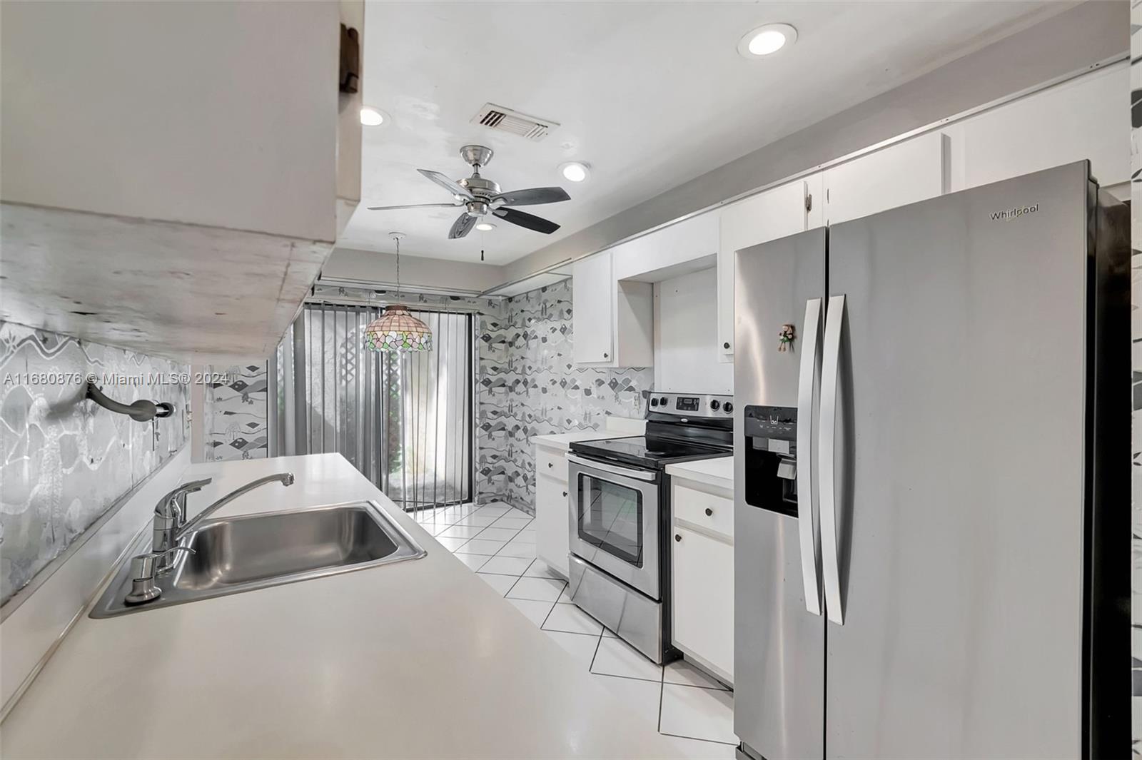 21864 Arriba Real, Unit 3E Boca Raton, FL 33433 - Photo 20 of 61 a kitchen with stainless steel appliances a stove a sink and a refrigerator