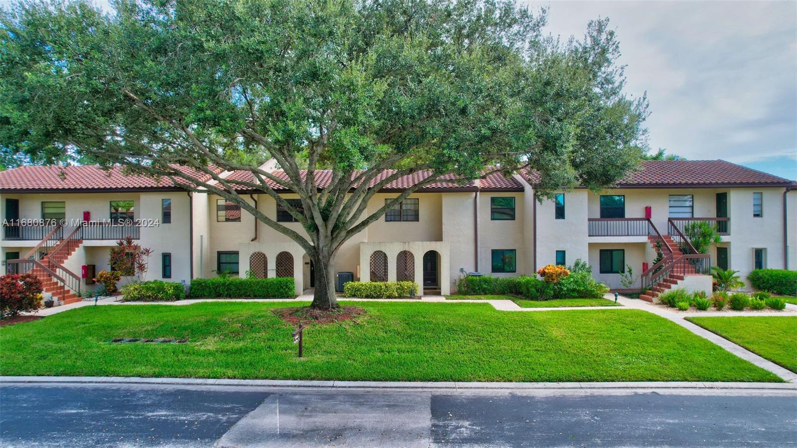 21864 Arriba Real, Unit 3E Boca Raton, FL 33433 - Photo 2 of 61 a front view of a house with a yard