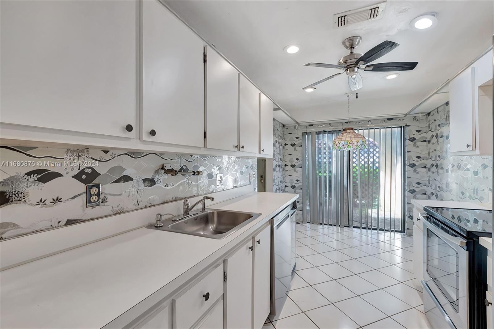 21864 Arriba Real, Unit 3E Boca Raton, FL 33433 - Photo 21 of 61 a kitchen with stainless steel appliances granite countertop a sink and a refrigerator