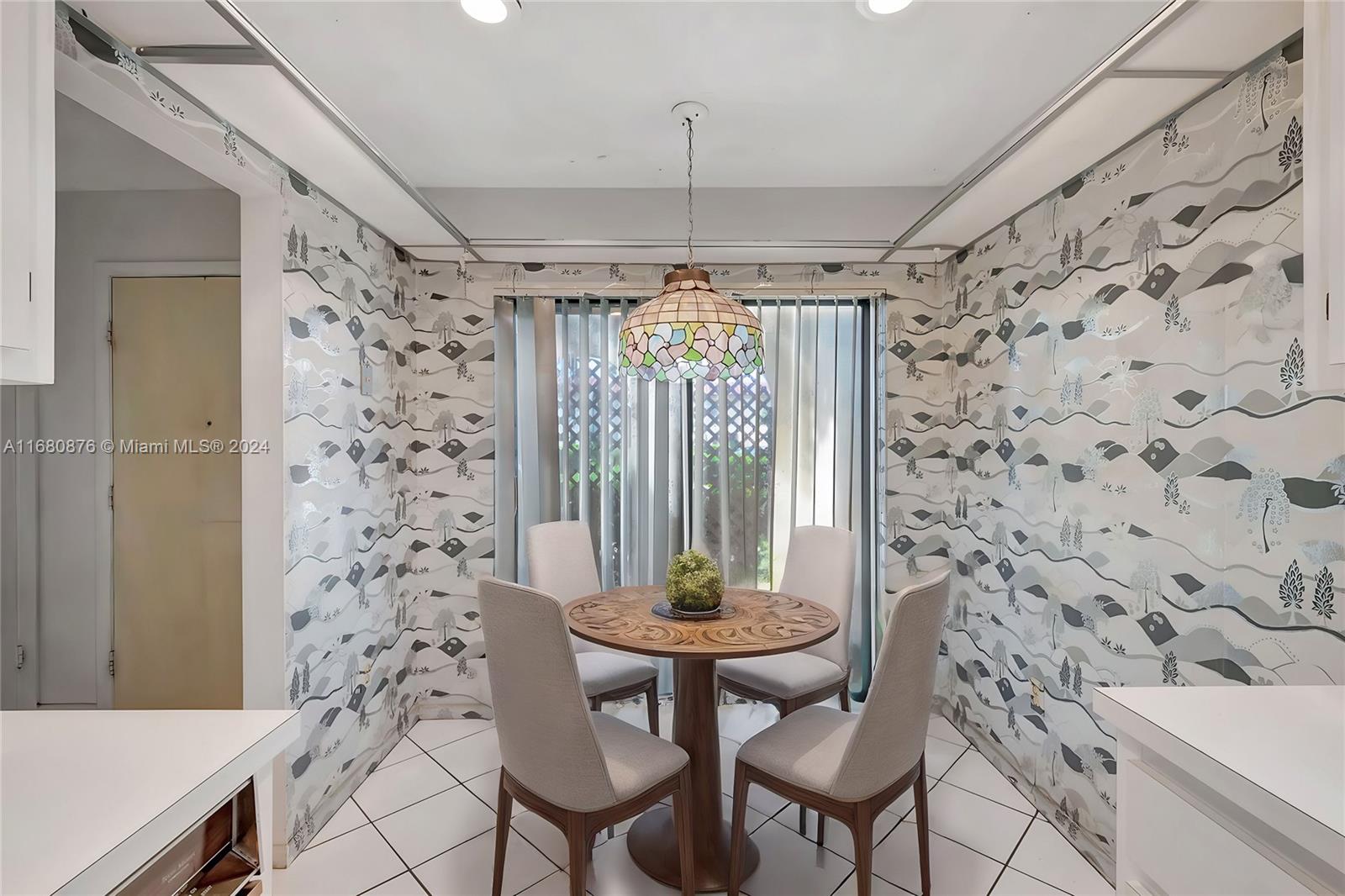 21864 Arriba Real, Unit 3E Boca Raton, FL 33433 - Photo 22 of 61 a room with a table and a chandelier