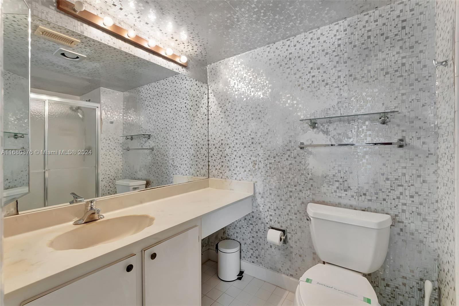 21864 Arriba Real, Unit 3E Boca Raton, FL 33433 - Photo 35 of 61 a bathroom with a granite countertop toilet a sink and mirror