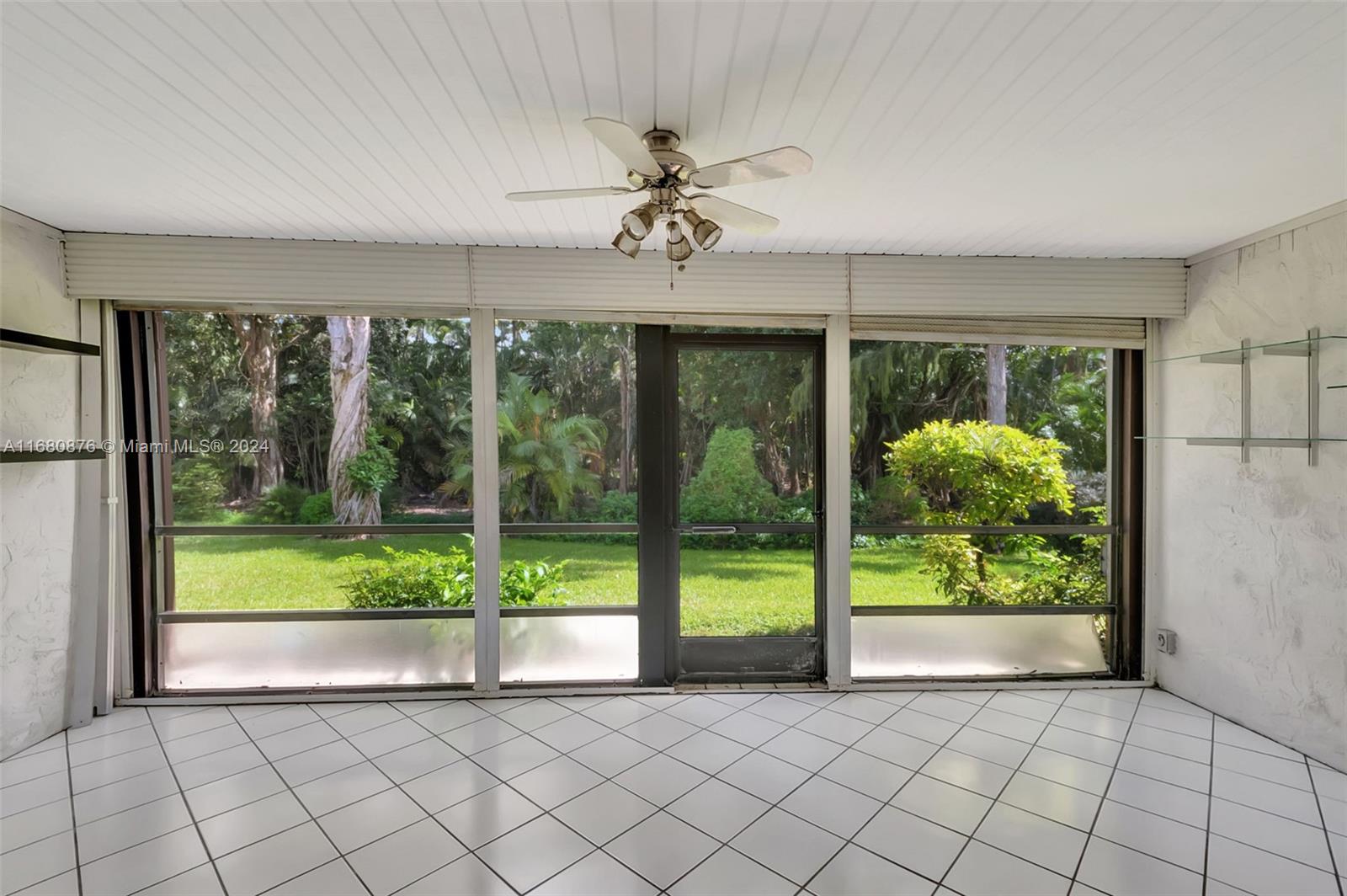 21864 Arriba Real, Unit 3E Boca Raton, FL 33433 - Photo 37 of 61 a view of an empty room with a large window closet and garden view