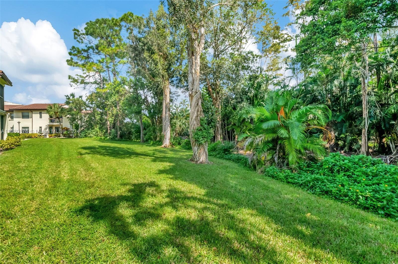 21864 Arriba Real, Unit 3E Boca Raton, FL 33433 - Photo 43 of 61 a view of a grassy field with trees