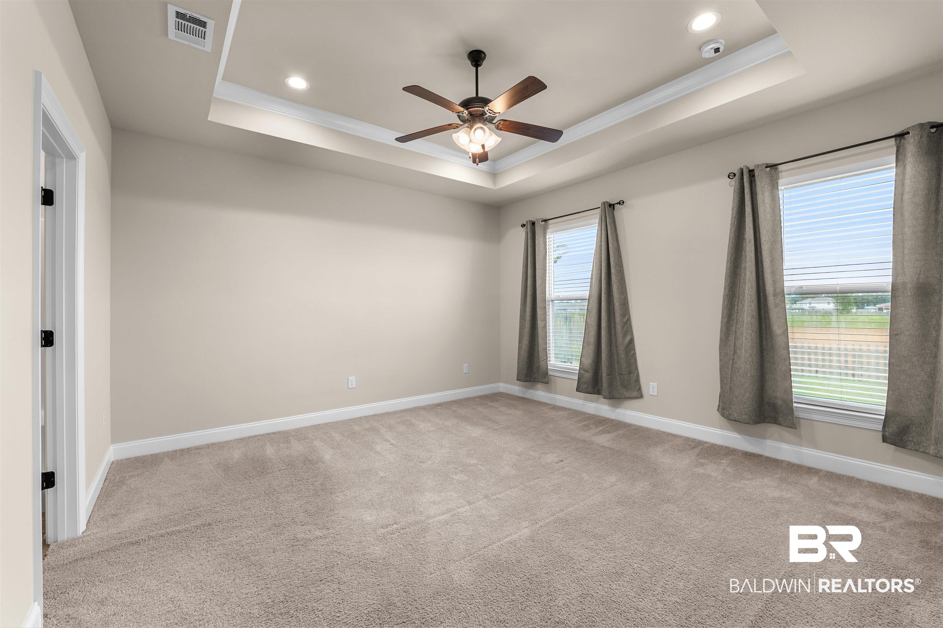 991 Dalton Circle Foley, AL 36535 - Photo 19 of 35 Empty room featuring a tray ceiling, ornamental molding, carpet, ceiling fan, and recessed lighting