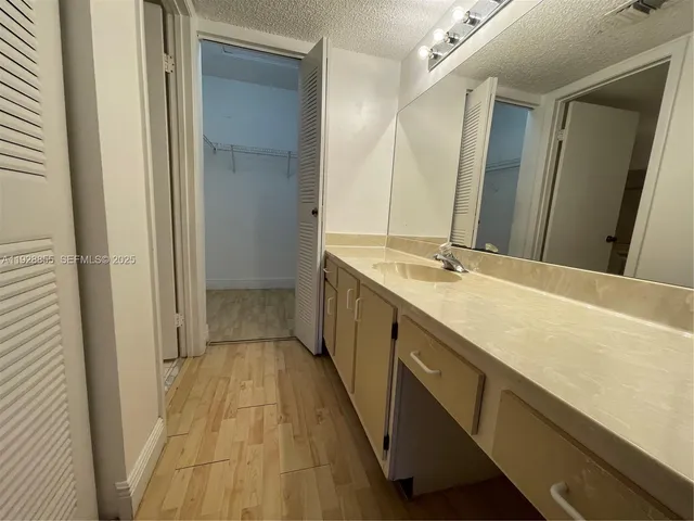a close view of a sink and dishwasher with wooden floor
