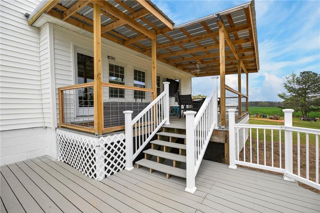 3590 Roosterville Road Roopville, GA 30170 - Photo 54 of 66 a view of a balcony with wooden floor and fence