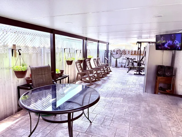 a dining room with furniture and a floor to ceiling window