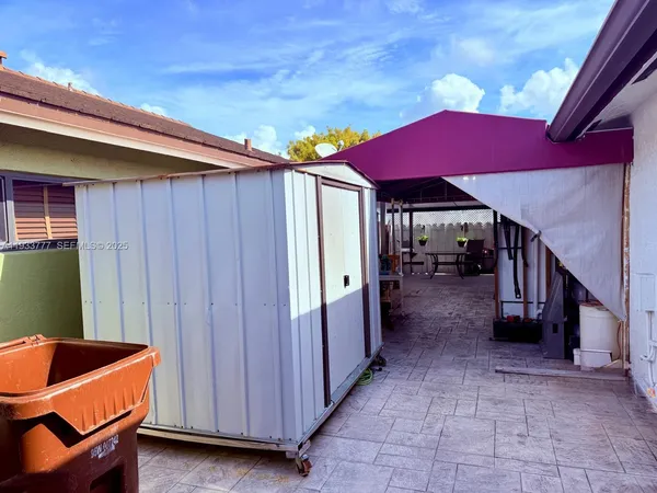 a view of backyard with outdoor seating and stairs