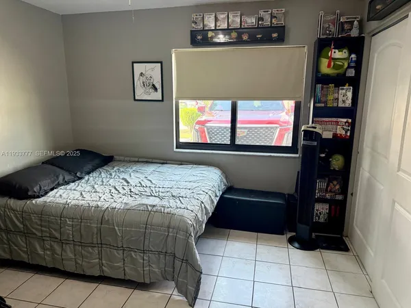 a bedroom with a bed and windows